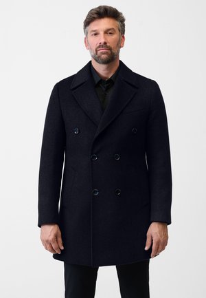 Doppelt geknöpfter Peacoat aus dunkelblauem Wollstoff. Mit großen Knöpfen, breiten Revers und Seitentaschen. Glatte Textur mit tailliertem Schnitt.