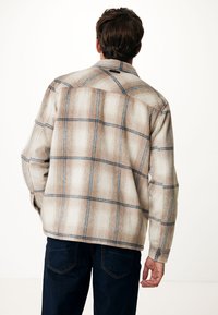 Beige plaid jacket with blue grid lines, made of textured fabric, featuring a collar and button cuffs. Back view shows simple stitching details.