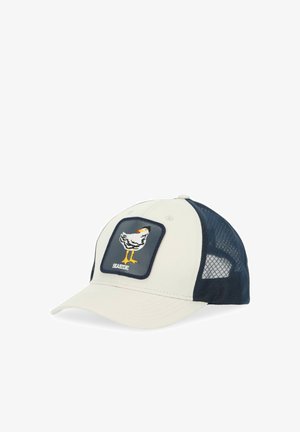 Hellbeige Kappe mit navyfarbenem Netz an den Seiten, mit einem gestickten Hühner-Patch auf der Vorderseite und einem gebogenen Schirm. Der Text lautet "SEASIDE".