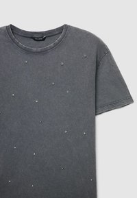 Gray cotton t-shirt featuring a crew neckline, short sleeves, and scattered silver gem-like embellishments on the front.