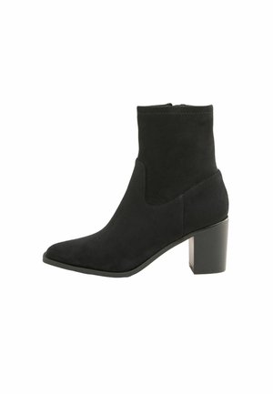 Black suede ankle boot with a block heel, pointed toe, and a snug fit, featuring a smooth texture and minimalistic design.