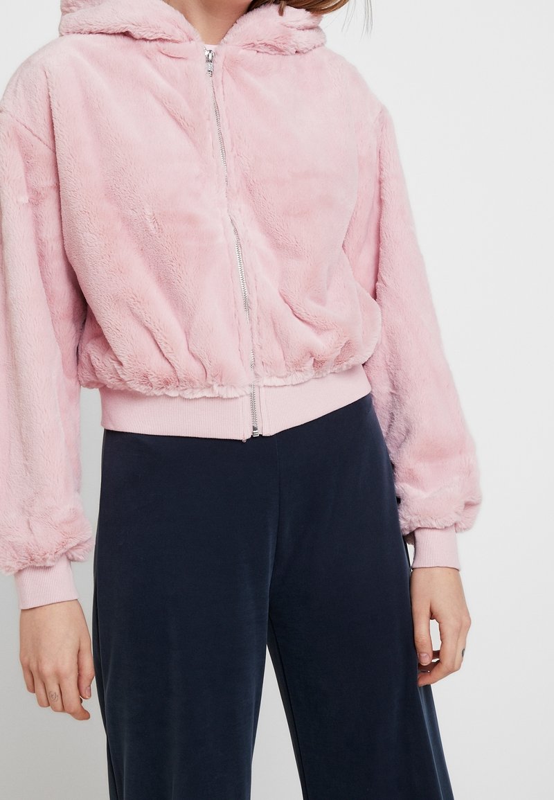 Rosa fodrad zip-up hoodie med en åtsittande midja och ärmslut, med huva och sidofickor för ökad detalj och komfort.