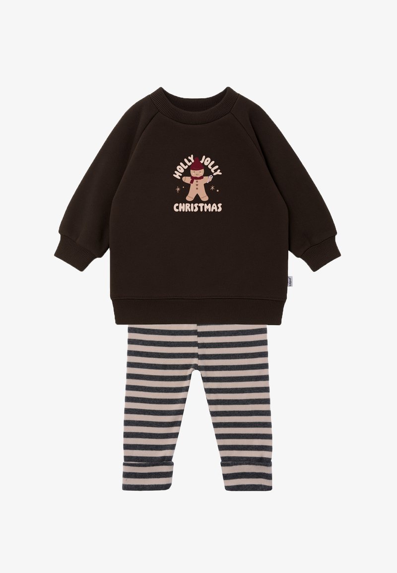 Dark brown sweatshirt with "Holly Jolly Christmas" print and a gingerbread character. Striped, beige and gray leggings with cuffed hems.