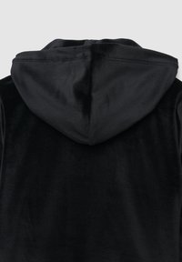 Giacca nera con cappuccio realizzata in un morbido tessuto vellutato. Presenta una texture semplice e liscia e un retro senza cuciture con cappuccio integrato.