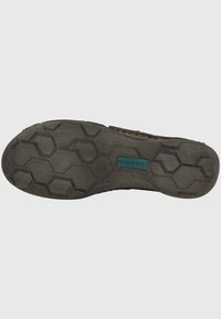 Suola di scarpa in gomma nera con un motivo a trama esagonale, superficie testurizzata e dettaglio del logo blu. Progettata per offrire aderenza e stabilità.