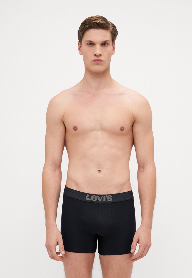 Schwarze Baumwoll-Boxershorts mit grauem, elastischem Bund, der das "Levi's"-Logo trägt. Enganliegendes Design mit glatter, weicher Textur.