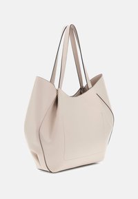 Borsa tote in pelle beige con una forma morbida e strutturata, cuciture nere a contrasto e due manici lunghi per il trasporto. Include una tasca frontale.