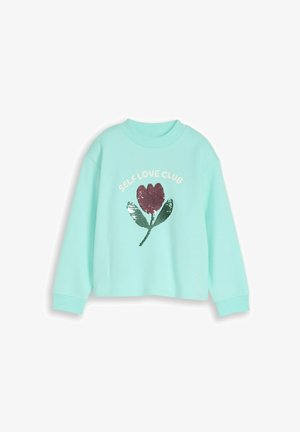 Hanorac bleu deschis cu floare mov din paiete și frunze verzi, text "SELF LOVE CLUB" deasupra florii.