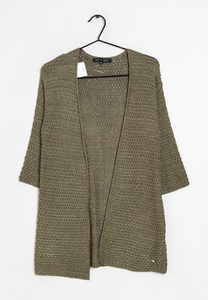 Cardigan vert en maille à ouverture devant avec manches trois quarts suspendu sur un cintre noir sur fond blanc.