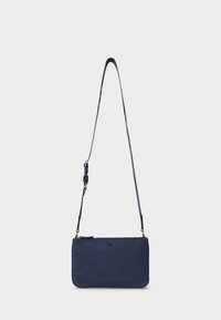 Navy blue crossbody bag made of smooth material, featuring a slim rectangular shape and a long adjustable strap. Subtle logo detail on front.