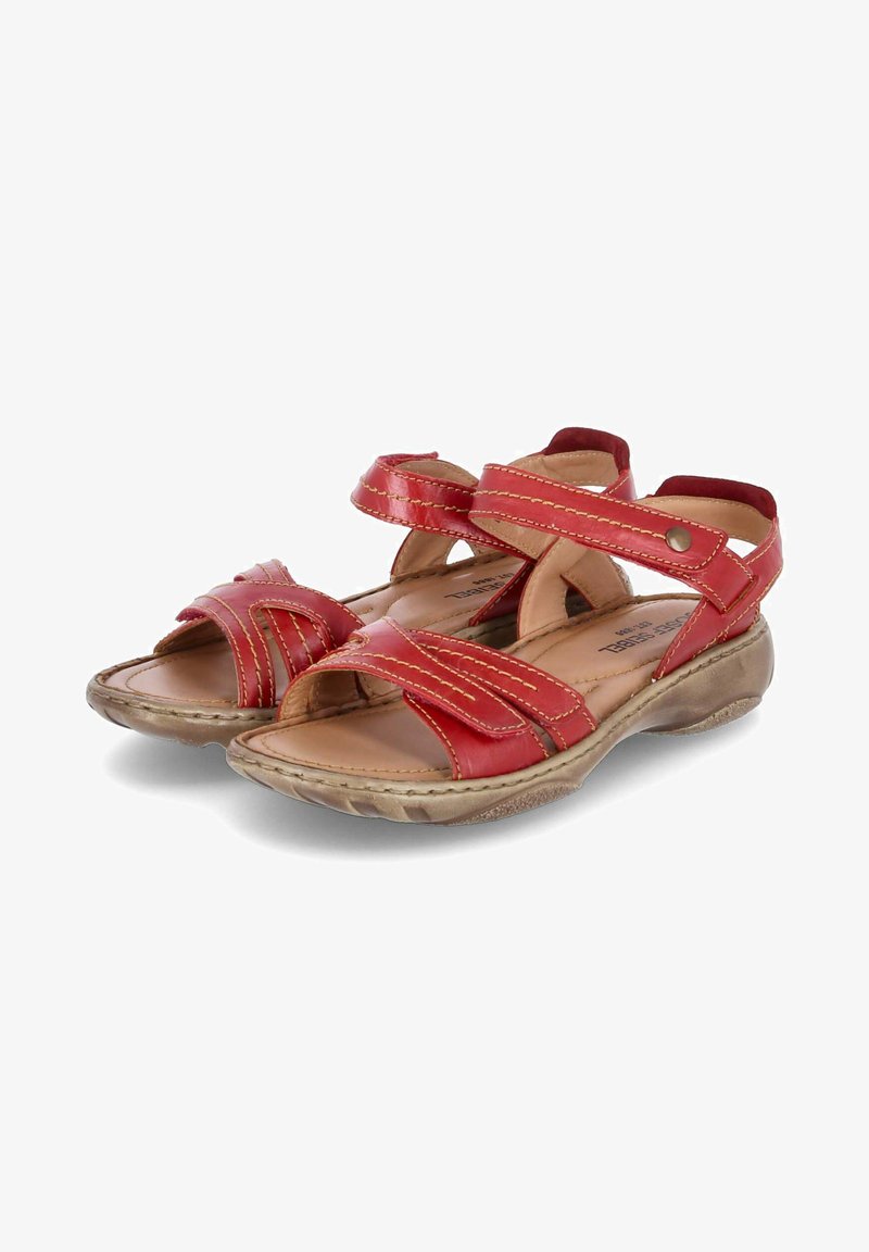Red leather sandals with cross-over straps, a padded insole, and a textured rubber sole for grip. Contrast stitching detail on straps.