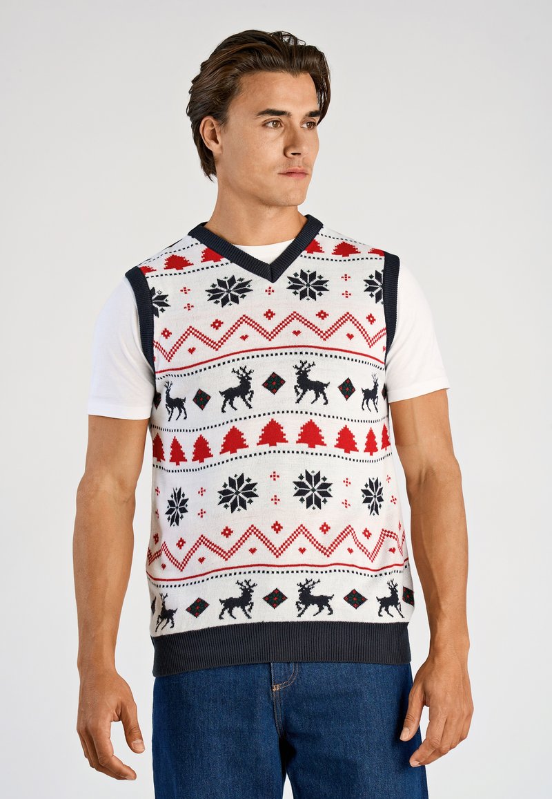 Gebreid mouwloos vest in wit met rode en zwarte kerstpatronen; met rendieren, sneeuwvlokken en bomen; marineblauwe bies en zoom.