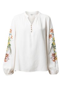 Vit långärmad blus med blommig broderi på ärmarna, träknappar på framfickan och elastiska ärmslut.