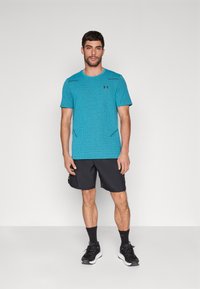 Under Armour VANISH SEAMLESS GRID - Sportovní tričko - circuit teal/black