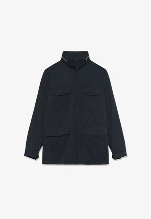 Tume sinine jakk kõrge kraega, millel on tõmblukk ja nööpidega suletavad kinnitused, neli esist taskut klapiga ja pikad varrukad.