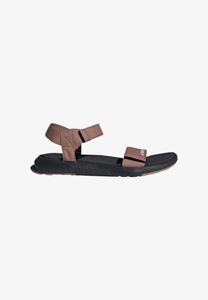 Brown fabric sandals with adjustable straps, a textured black rubber sole, and a minimalist design suitable for casual wear.