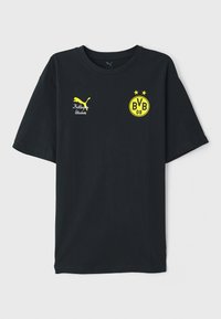 Svart bomulls T-skjorte med gule grafikker. Har Puma-logo, "KidSuper Studios" tekst, og et "BVB 09" emblem med to stjerner. Korte ermer.