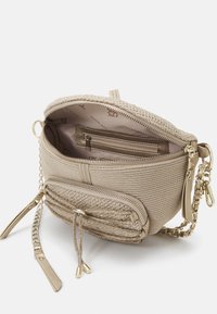 Beige strukturiert Umhängetasche mit goldener Kettenriemen, vorderer Reißverschluss-Extraschlaufe mit Zugband und sichtbarem Innenreißverschlussfach sowie Markenfutter.