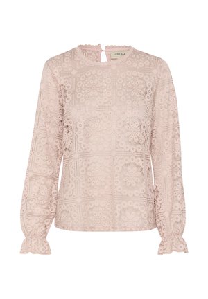 Lace blouse in soft pink, featuring intricate floral and geometric patterns, long sleeves with ruffled cuffs, and a keyhole back opening.