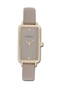 Montre rectangulaire en or avec un cadran gris brossé, mouvement à trois aiguilles et un bracelet en cuir gris clair. Présente un design minimaliste et un logo.