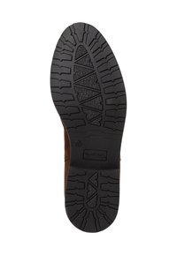 Semelle en caoutchouc d'une botte marron avec une surface texturée et des profondeurs disposées en zigzag pour une meilleure traction et adhérence.