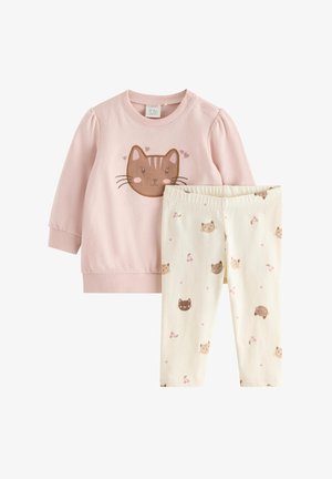 Pink long-sleeve top with a brown cat face and cream leggings printed with small cat faces and pink cherry clusters.
