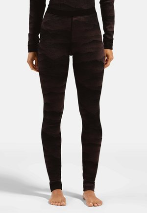 Hoch geschnittene schwarze Leggings mit strukturiertem Wellenmuster, elastischem Bund und figurbetontem Design. Das Material scheint dehnbar und weich zu sein.
