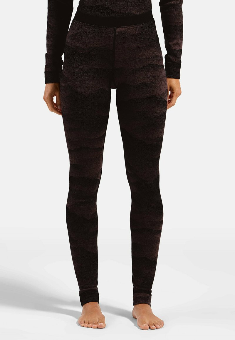 Hoch geschnittene schwarze Leggings mit strukturiertem Wellenmuster, elastischem Bund und figurbetontem Design. Das Material scheint dehnbar und weich zu sein.
