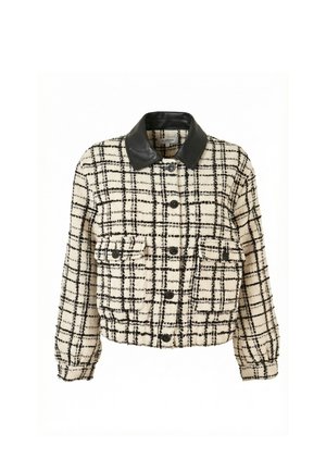 Giacca a quadri crema e nera con colletto in pelle nera, chiusura frontale con bottoni e due tasche con patta sul petto.