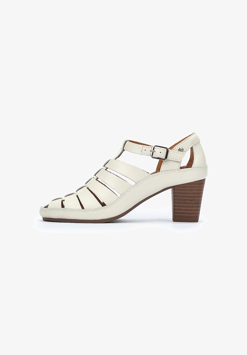 White leather heeled sandal with open toe, featuring crisscross straps, adjustable ankle strap, and a textured brown heel.