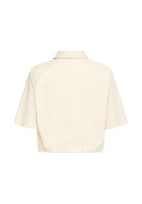 Veste courte écrue à manches courtes avec col et bord élastique, vue de dos sur fond blanc.