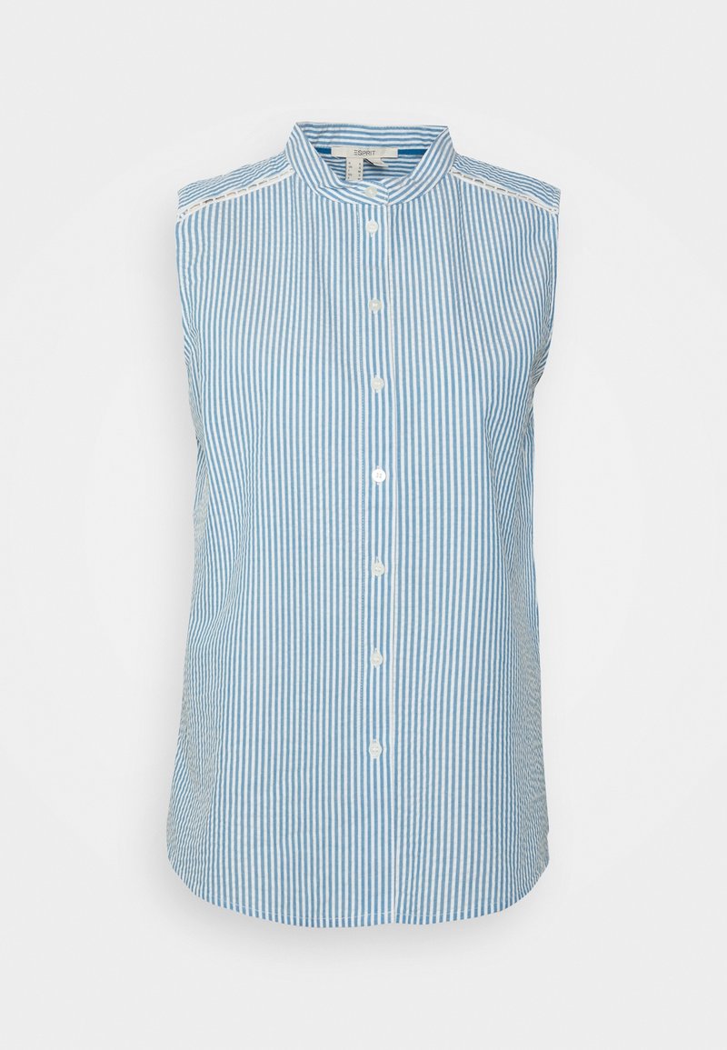 Chemise sans manches à boutons en bleu clair et blanc rayé, dotée d'un col pointu et d'une légère courbe à l'ourlet pour un ajustement cintré.
