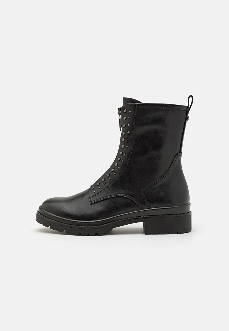 Black leather ankle boot with a side zipper, studded detailing, round toe, and textured rubber sole. Features a pull tab for easy wear.