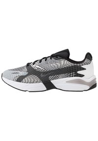 Scarpe sportive con un design bianco e nero, dotate di una tomaia in mesh, pattern testurizzati, punta arrotondata e suola ammortizzata.