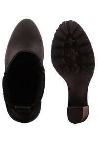 Botín negro hasta el tobillo con un upper sintético liso, paneles laterales elásticos y una suela de goma texturada con un diseño de dibujo para mayor agarre.