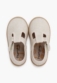 Beige stoffen schoenen met uitsnijdingen aan de zijkanten, een zachte voering en een klittenbandsluiting. Natuurlijke textuurzool. Fabrikantlogo zichtbaar aan de binnenkant.