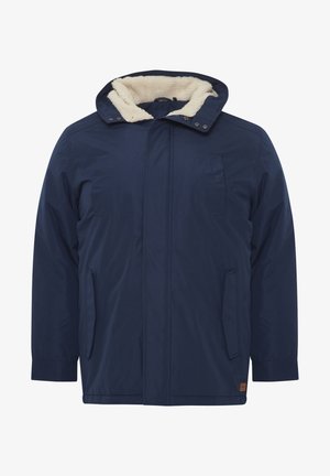 Navy blue padded jacket with a faux fur-lined hood, front zip, side pockets, and a relaxed fit. Soft texture with reinforced stitching.