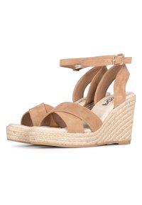 Sandali con zeppa in suede beige con cinturini incrociati, fibbia alla caviglia e dettagli in iuta intrecciati su una suola spessa. Soletta morbida per il massimo comfort.