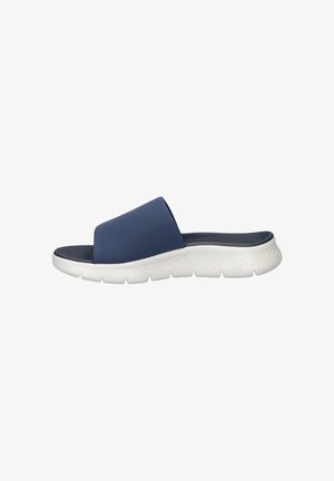 Navy blue slide sandal with wide fabric strap, cushioned textured insole, and thick white rubber sole designed for comfort.
