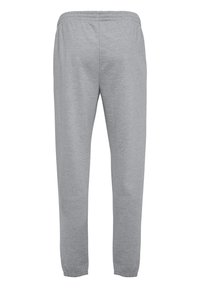 Graue Sweatpants aus weichem Stoff, mit einem elastischen Bund und elastischen Bündchen an den Knöcheln. Einfaches und schlichtes Design.