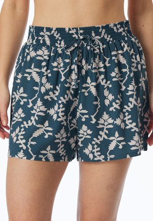 Teal shorts with a white botanical pattern, featuring an elastic waistband and drawstring. Fabric appears lightweight and smooth.