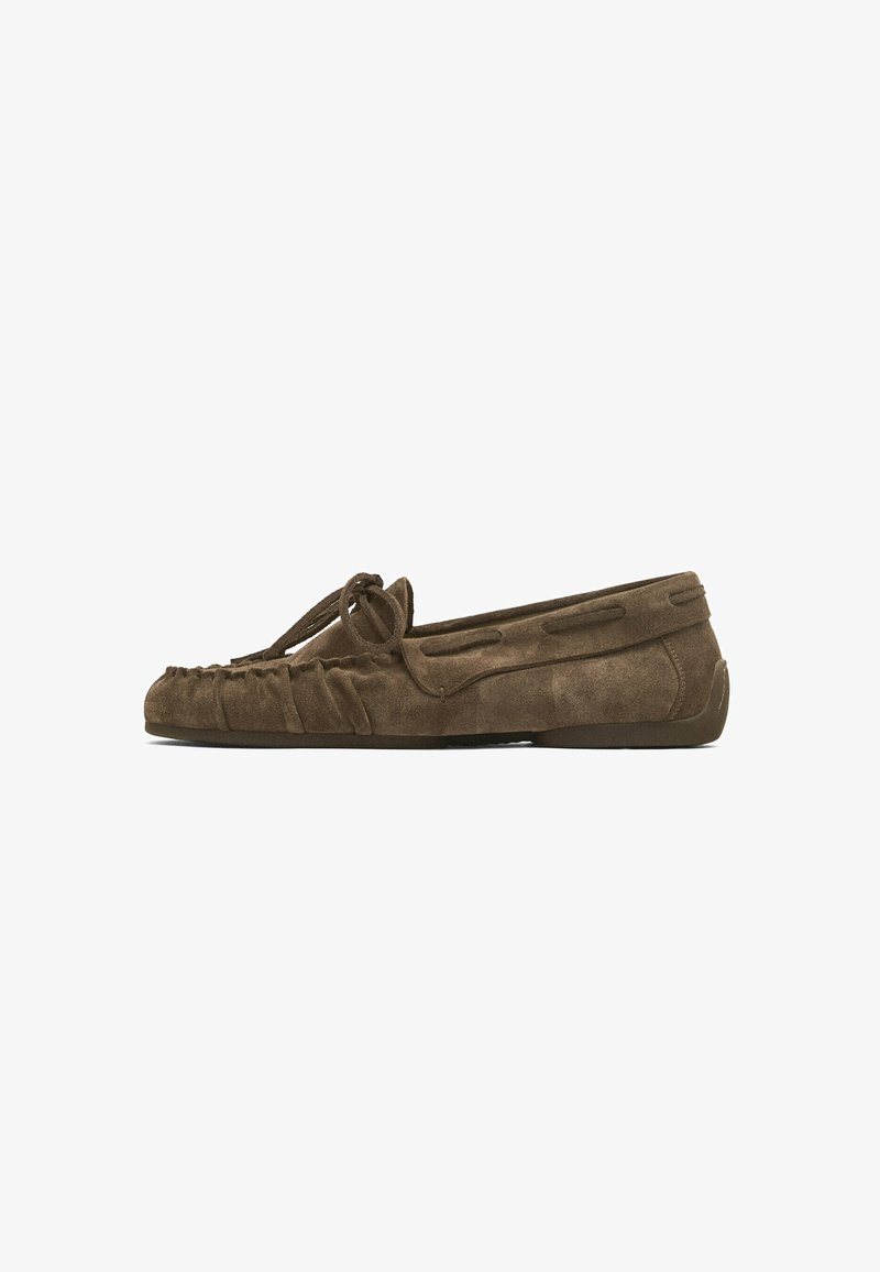 Suede loafers in dark brown with a gathered design, bow detail on the front, and a flat, rubber sole for comfort.