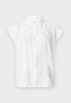 Hvid kortærmet skjorte med knapper, klassisk krave og voluminøse stofdetaljer på skuldrene.