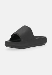 Black slide sandals with a textured upper, open toe, and flat rubber sole. Features a wide strap and a minimalist design.
