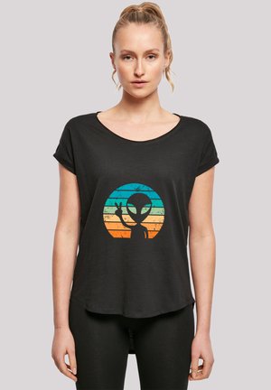 Black short-sleeve T-shirt featuring a colorful alien graphic set within a circular design with gradient stripes in blue, orange, and yellow.