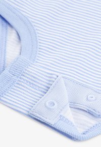 Bledomodrý prúžkovaný detský overal z mäkkého bavlneného materiálu, s okrúhlym výstrihom a zapínaním na patentky v spodnej časti pre jednoduché obliekání.