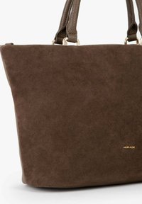 Borsa tote in suede marrone con manici in pelle, caratterizzata da una forma strutturata e un design minimalista. Accento del logo dorato sul lato.