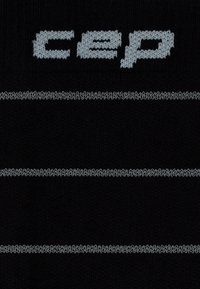 Black socks featuring a textured knit pattern, with two horizontal gray stripes and the "CEP" logo woven in gray near the top.