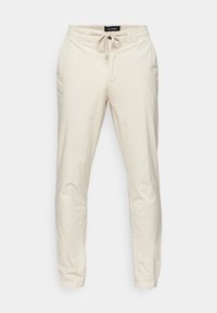 Bež hlače z elastičnim pasom in vrvicami. Imajo stranske žepke in tapered kroj nog. Gladek, lahkoten material.
