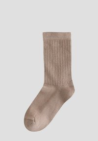 Chaussettes en beige côtelées avec une texture lisse, de longueur mi-mollet et légèrement extensibles. Bout arrondi et talon renforcé pour plus de durabilité.